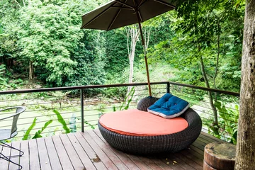 Fototapeten Cushion with umbrella in natural park. © Kobchai M.