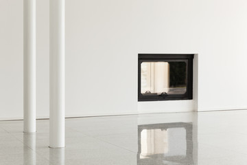 empty room with pillar and fireplace