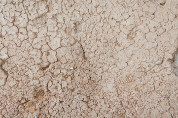 Old crackes pale yellow wall with grey bricks