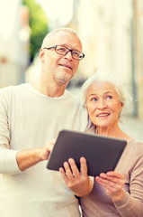 senior couple photographing on city street