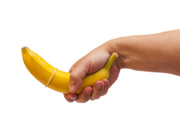 Condom on banana in hand isolated on white background 