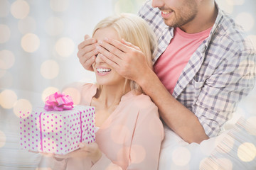 happy man giving woman gift box at home