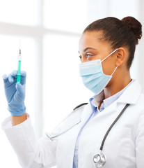 african doctor holding syringe with injection