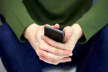close up of male hands with smartphone
