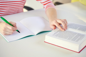 close up of female hands with book and notebook