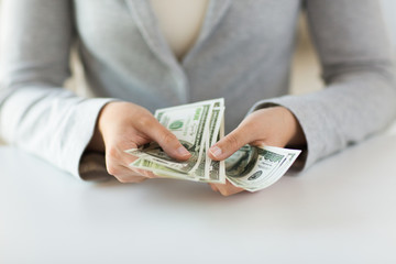 close up of woman hands counting us dollar money