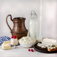 Dairy products on white wooden background.