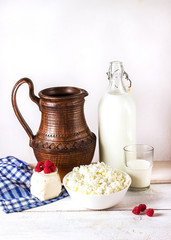 Dairy products on white wooden table.