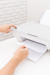 Man's hand working with printer