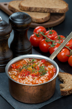 Spicy tomato soup with rice and vegetables in a saucepan