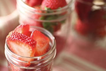 Glass jars with strawberries