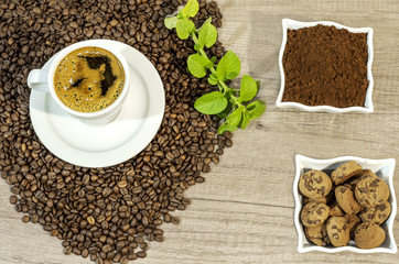 Cup of fresh coffee, coffee beans,  fresh ground coffee, cookies