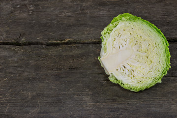 Green cabbage on an old wood rustic background