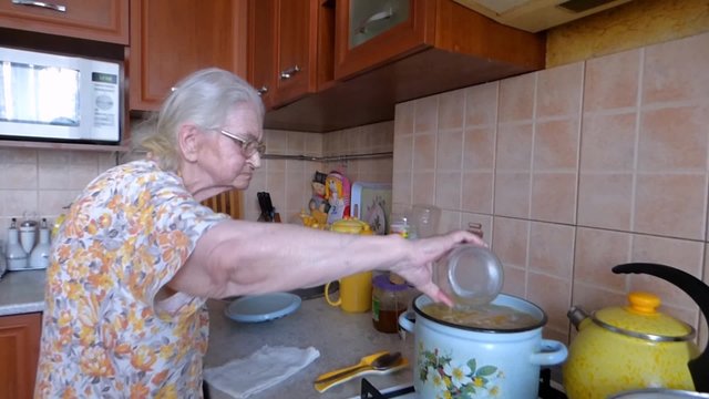 Grandmother cooks a very tasty soup