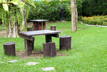 table and chairs standing on a lawn at the garden