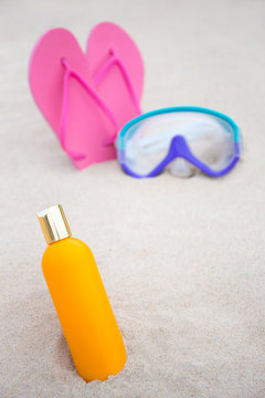 skin care concept - close up of suntan lotion bottle, diving mas