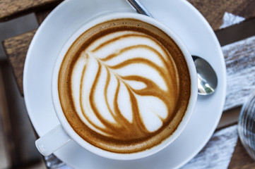 Cup of freshly made espresso on wood board