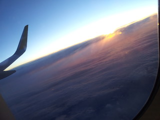 Flying above the clouds at the sunset time