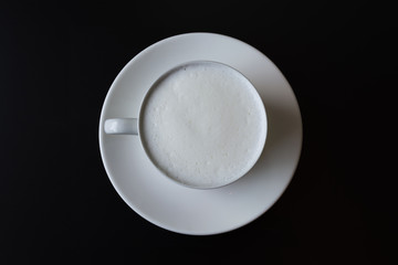 Hot milk cup on black table