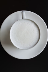 Hot milk cup on black table