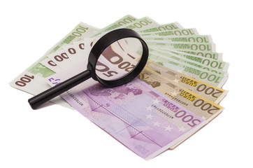 Euro banknote under magnifying glass 