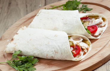 Shawarma, turkish doner kebab, roll with meat and pita bread on