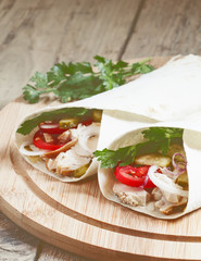 Shawarma, turkish doner kebab, roll with meat and pita bread on