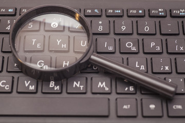 Magnifying Glass on black keyboard