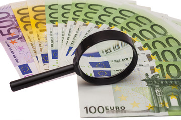 Euro banknote under magnifying glass