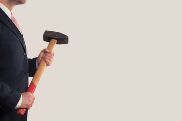 Businessman holding a sledgehammer in his hands - obrazy, fototapety, plakaty