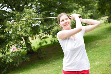 young woman playing golf