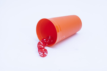 Red dice cup with five red winning dice