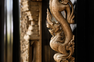 Fototapeta na wymiar Wood carving designs into ancient animal.