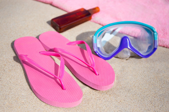 summer concept - flip flops, towel, diving mask and suntan lotio