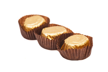 Gold chocolate bonbons isolated on white background