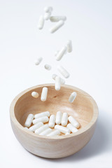 falling of white capsules medicine