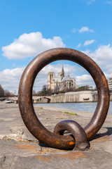 Fototapeta premium blurred view of Notre Dame trough Ring for anchoring boats along the Seine river