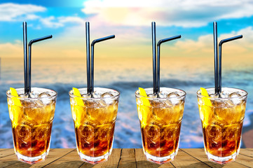  Four Cuba libre exotic tasty cocktail with beautiful sunset bac