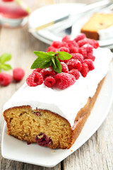 Raspberry cake on plate on grey wooden background