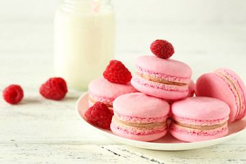 Raspberry macarons on white wooden background