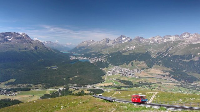 Panorama of the Upper Engadine from Muottas Muragl with very steep trail