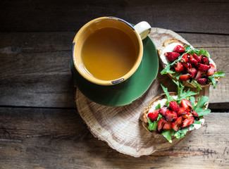 bruschetta with cheese, arugula, strawberries