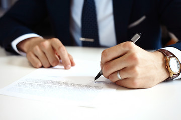 Businessman signing a document.