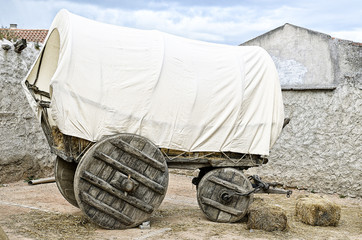Vintage covered wagon used to transport straw, people and others things in western time