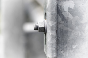 Bolt with screw and washer, located on a guard rails, near a road