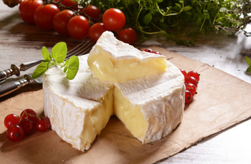 Camembert cheese on a rustic background