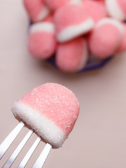 Pink gummy sweets with sugar, top view