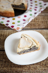 Slice of homemade poppy seed pie with pastry hearts