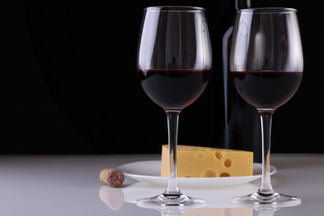 Glasses with wine and cheese