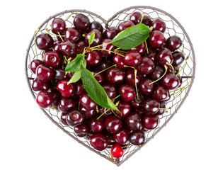 cherries in a heart-shaped metallic basket isolated on white